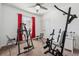 A bedroom with exercise equipment features carpeted floors, a ceiling fan, and natural light from the window at 3422 Seneca Club Loop # 57, Orlando, FL 32808