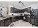 Efficient kitchen featuring dark cabinetry, granite countertops, and tile flooring at 3422 Seneca Club Loop # 57, Orlando, FL 32808