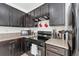 Kitchen featuring dark wood cabinets, countertops and modern appliances at 3422 Seneca Club Loop # 57, Orlando, FL 32808