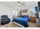 A cozy main bedroom features carpeted floors, a ceiling fan, and natural light from the windows at 3422 Seneca Club Loop # 57, Orlando, FL 32808