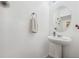 A pristine powder room with a stylish pedestal sink and modern fixtures at 3422 Seneca Club Loop # 57, Orlando, FL 32808