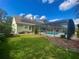 Exterior view shows a lovely home with a backyard, pool, and solar panels on the roof at 413 Country Wood Cir, Lake Mary, FL 32746