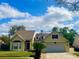 Charming two-story home featuring manicured lawn and a bright, inviting facade under a sunny sky at 413 Country Wood Cir, Lake Mary, FL 32746