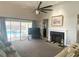 Bright living room with a fireplace, large windows overlooking the pool, and comfortable seating area at 413 Country Wood Cir, Lake Mary, FL 32746