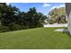 Large, well-maintained backyard featuring a lush green lawn and mature trees, perfect for outdoor activities at 420 Marion Oaks Crse, Ocala, FL 34473
