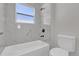 Bathroom features a tub with shower and white tiled walls at 420 Marion Oaks Crse, Ocala, FL 34473