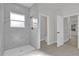 Bathroom with a white-tiled shower and natural light at 420 Marion Oaks Crse, Ocala, FL 34473