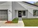 View of the home's front door, including the walkway to the house at 420 Marion Oaks Crse, Ocala, FL 34473