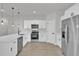 Bright kitchen featuring stainless steel appliances, white cabinets, quartz countertops, and hardwood floors at 420 Marion Oaks Crse, Ocala, FL 34473