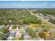 Scenic aerial view of a residential area with lush greenery, nearby lake, and easy access to major roads at 4371 Weeping Willow Cir, Casselberry, FL 32707