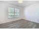 Bright bedroom featuring light gray flooring, natural lighting, and large window with backyard views at 4371 Weeping Willow Cir, Casselberry, FL 32707