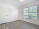 Bright bedroom featuring light gray flooring, natural lighting, and large window at 4371 Weeping Willow Cir, Casselberry, FL 32707