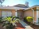 Close-up of front entrance showcasing a well-maintained yard and attractive architectural details at 4371 Weeping Willow Cir, Casselberry, FL 32707