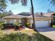 Charming single-story home featuring a two-car garage, manicured lawn, and inviting front entrance at 4371 Weeping Willow Cir, Casselberry, FL 32707