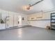 Spacious two car garage with storage cabinets and white painted walls at 4371 Weeping Willow Cir, Casselberry, FL 32707