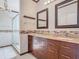 Beautiful main bathroom featuring dual sinks, granite countertops, mosaic backsplash, and tiled shower at 4371 Weeping Willow Cir, Casselberry, FL 32707