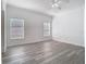 Bright main bedroom features two windows, light gray flooring, and a ceiling fan at 4371 Weeping Willow Cir, Casselberry, FL 32707