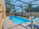 Screened-in pool and spa with patio and chairs in backyard at 4371 Weeping Willow Cir, Casselberry, FL 32707