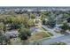 Aerial view of a home surrounded by lush greenery in a vibrant neighborhood with a clear view of city skyline at 5108 Balboa Dr, Orlando, FL 32808