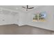 Bright living room featuring tile floors, a modern ceiling fan, and natural light streaming through large windows at 5108 Balboa Dr, Orlando, FL 32808