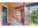 Hallway view features a blue front door, view of outside greenery and stairway with handrail at 5120 Conroy Rd # 32, Orlando, FL 32811