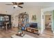 Inviting living room with hard floors, a ceiling fan and bookshelf, seamlessly flowing into the dining area at 5120 Conroy Rd # 32, Orlando, FL 32811