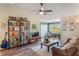 Bright living room with wood floors, ceiling fan, a bookshelf and a large window with natural light at 5120 Conroy Rd # 32, Orlando, FL 32811