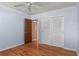 Bedroom featuring hardwood floors, closet, and entry to ensuite bathroom at 625 Brechin Dr, Winter Park, FL 32792