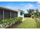 Backyard shows a lawn, landscaping, and screened in porch attached to the home at 625 Brechin Dr, Winter Park, FL 32792