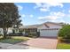 Inviting home showcasing a brick driveway leading to an attached garage and landscaped front yard at 625 Brechin Dr, Winter Park, FL 32792