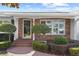 Close-up of the brick-paved entryway with decorative columns and trimmed hedges at 625 Brechin Dr, Winter Park, FL 32792