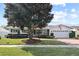 Charming single-story home featuring a manicured lawn and lovely landscaping with mature tree, and attached two car garage at 625 Brechin Dr, Winter Park, FL 32792