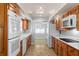 Spacious kitchen featuring abundant cabinetry, white appliances, and a seamless flow into the breakfast nook at 625 Brechin Dr, Winter Park, FL 32792