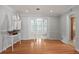 Spacious living room featuring hardwood floors and doorway leading to another room with french doors at 625 Brechin Dr, Winter Park, FL 32792