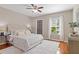 Serene bedroom features a ceiling fan, a walk-in closet and a large window at 6542 Swissco Dr # 813, Orlando, FL 32822