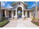 Welcoming clubhouse entrance with a grand archway, white columns, and well-maintained landscaping at 6542 Swissco Dr # 813, Orlando, FL 32822