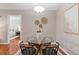 Bright dining area featuring a glass table, black chairs, and contemporary wall decor at 6542 Swissco Dr # 813, Orlando, FL 32822