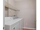 Functional laundry room with a washer, dryer, and storage shelving at 6542 Swissco Dr # 813, Orlando, FL 32822