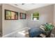 Relaxing bedroom corner featuring a blue chaise lounge and view of the outdoors at 705 Liberty St, Eustis, FL 32726