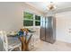 Bright kitchen with dining table, modern refrigerator, lots of natural light, and neutral colors at 705 Liberty St, Eustis, FL 32726