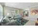 Open living room flows into kitchen featuring tile floors, stainless steel appliances, and modern lighting at 705 Liberty St, Eustis, FL 32726