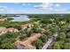 Panoramic aerial view of buildings, lush trees, a tranquil lake, and dedicated parking at 7123 Yacht Basin Ave # 328, Orlando, FL 32835