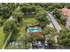 Aerial view of the community swimming pool surrounded by mature landscaping and ample parking at 7123 Yacht Basin Ave # 328, Orlando, FL 32835