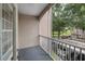 Comfortable balcony offers fresh air and natural light with a pleasant view of mature trees and assigned parking at 7123 Yacht Basin Ave # 328, Orlando, FL 32835