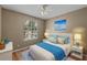 Cozy bedroom featuring natural light and a ceiling fan at 7123 Yacht Basin Ave # 328, Orlando, FL 32835