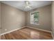 Bedroom with wood floors, ceiling fan, and a window at 7123 Yacht Basin Ave # 328, Orlando, FL 32835