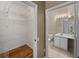 A walk-in closet flows into the en-suite bathroom at 7123 Yacht Basin Ave # 328, Orlando, FL 32835