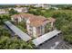 A charming condo building with lush landscaping and covered parking spots at 7123 Yacht Basin Ave # 328, Orlando, FL 32835