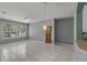 Bright living room featuring white tile flooring, a ceiling fan, and a large window for ample natural light at 7123 Yacht Basin Ave # 328, Orlando, FL 32835