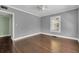 Bedroom featuring hardwood floors, neutral paint, a ceiling fan, and a bright window at 728 N Summerlin Ave, Orlando, FL 32803